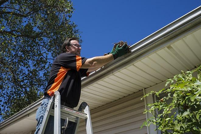 a technician repairing a gutter system in Beverly Hills